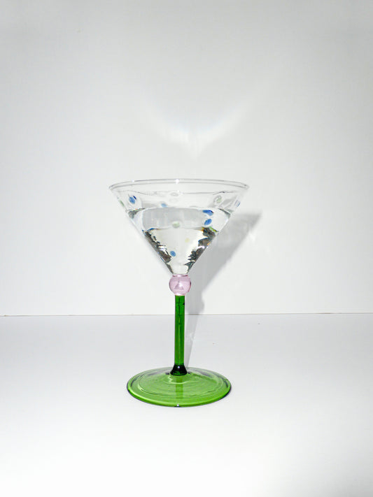 front facing image of one martini glass with green stem and colourful polka dot detailing