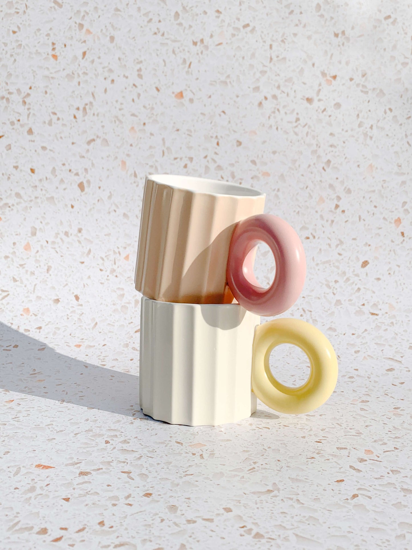 Ribbed mug set of two. Large chunky handle. Pastel pink and yellow.