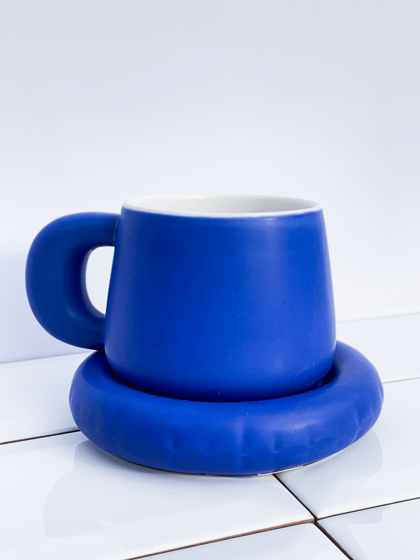 Blue ceramic coffee cup and saucer