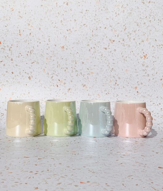 Image of a set of 4 ceramic mugs. Cute colourways. Perfect mugs for gifts.