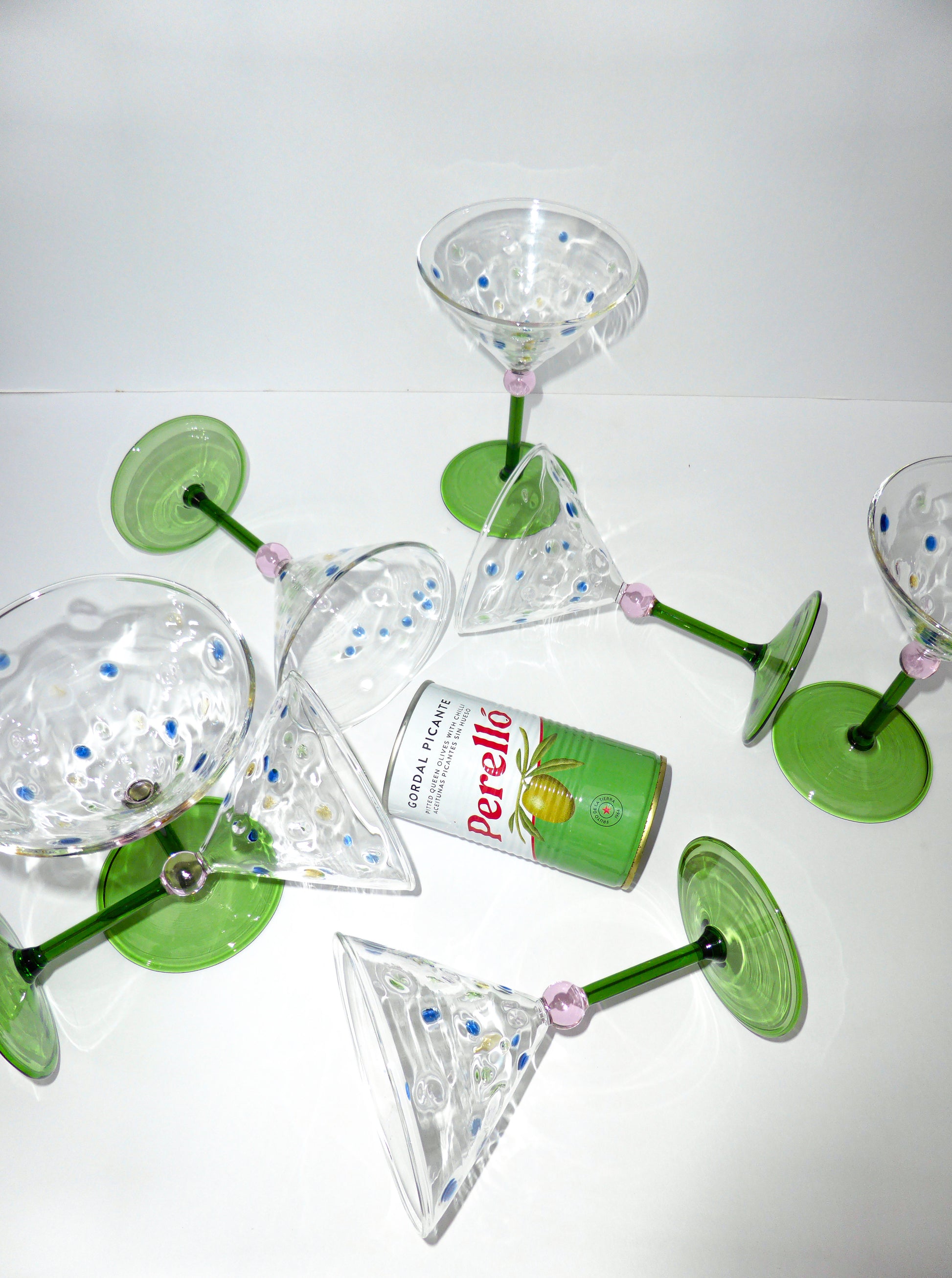 Image of of multiple unique colourful martini glasses stud up and lay down 