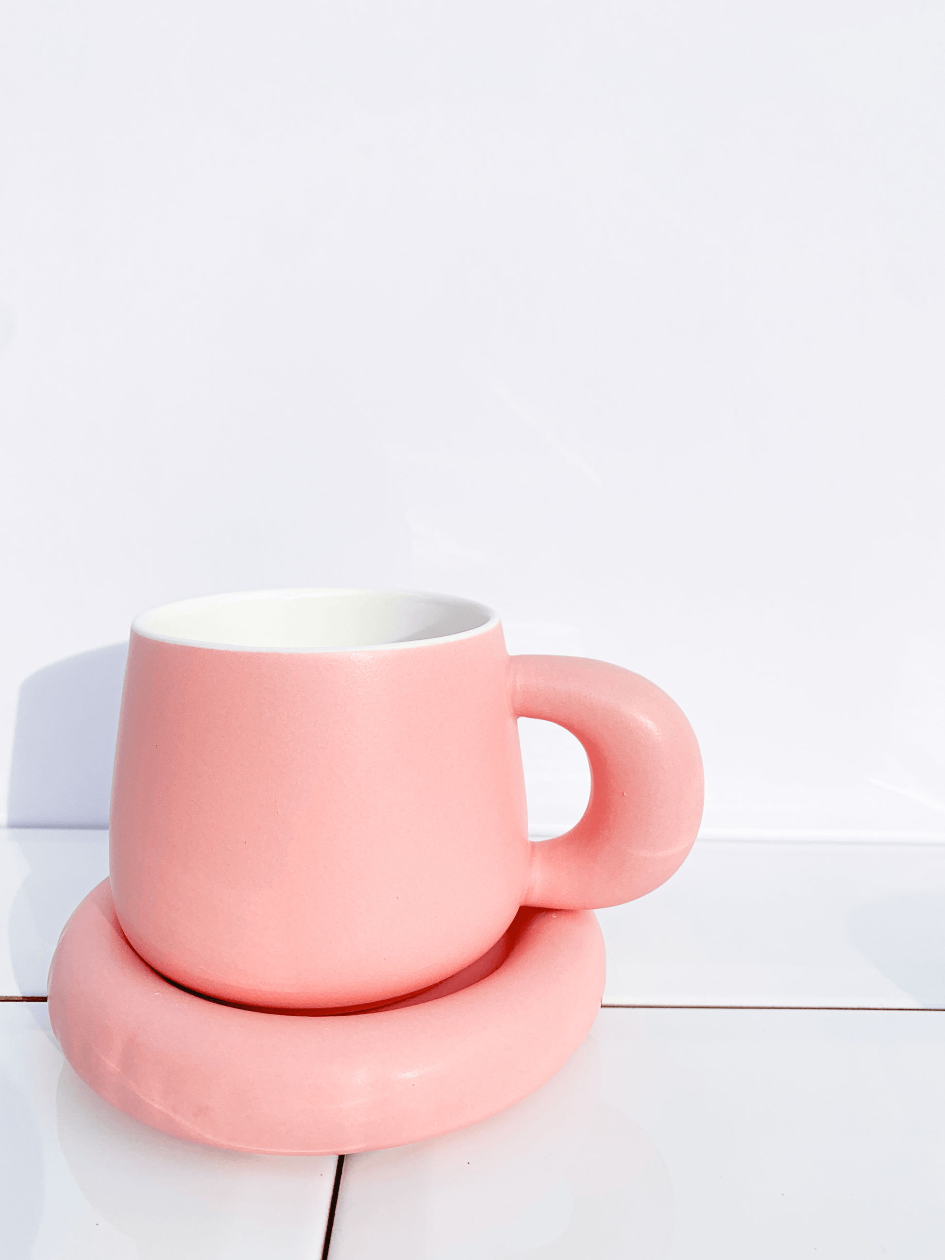 Baby pink ceramic coffee cup and saucer
