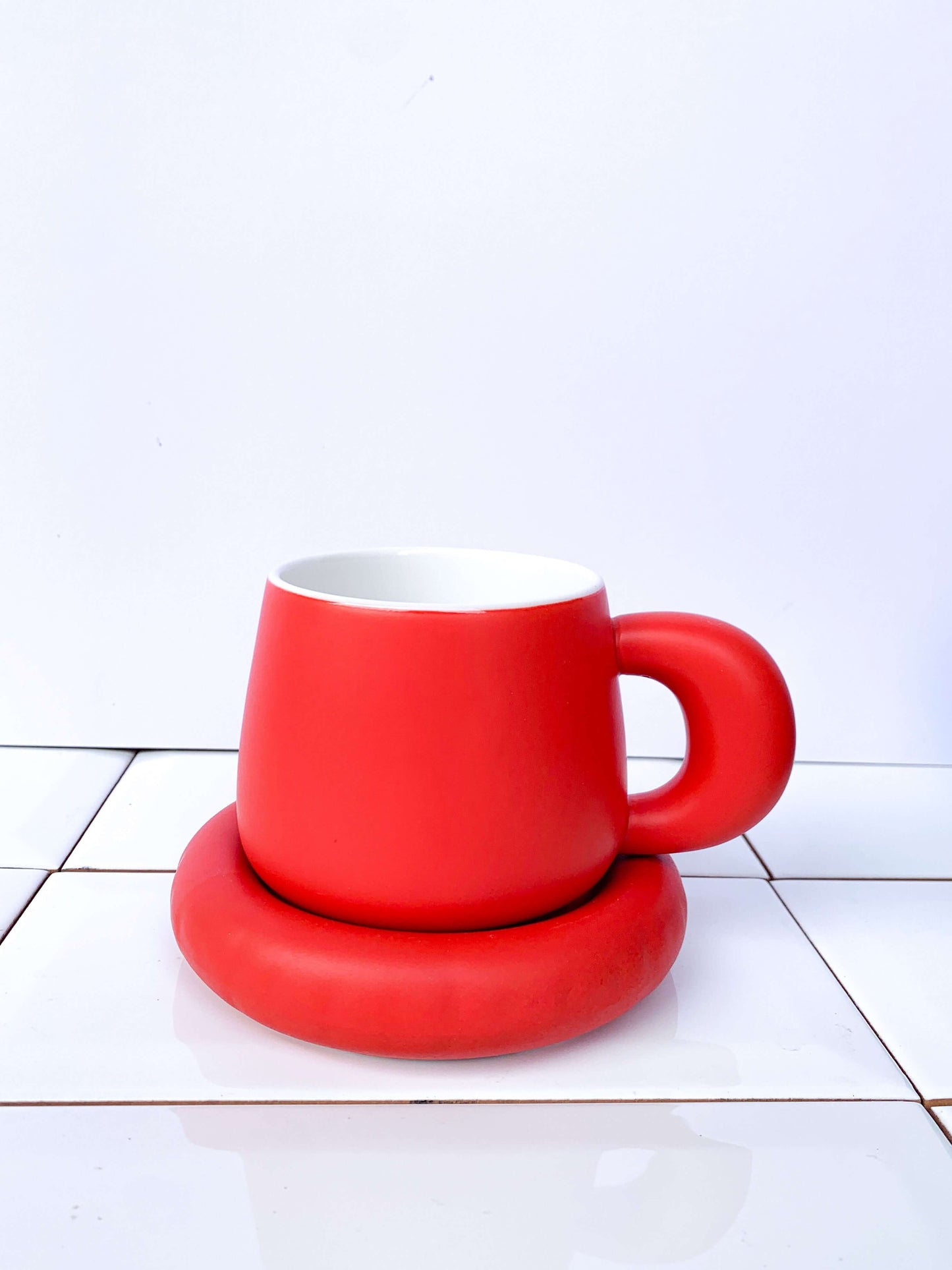 red ceramic cup and saucer. Gustaf westman style. Perfect for homeware gift