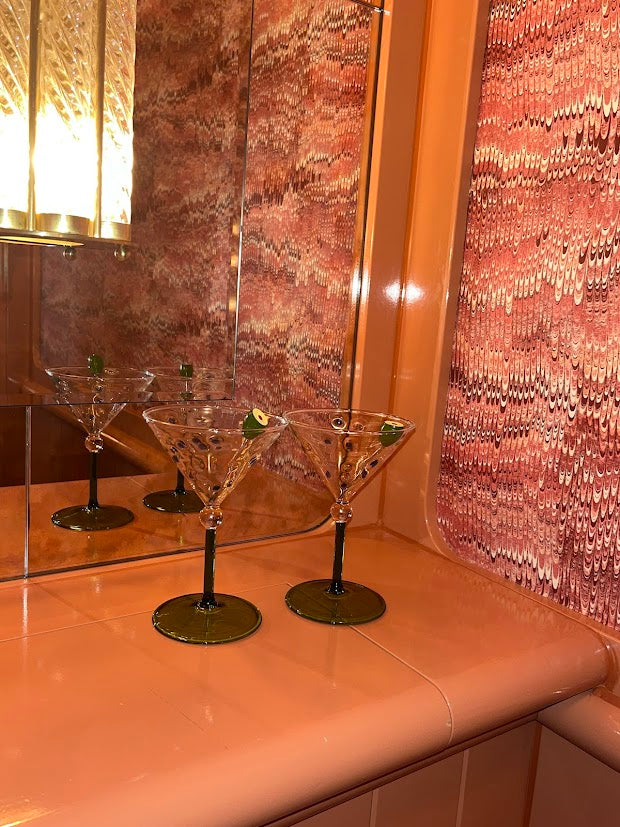 Image of two luxury art deco martini glasses in a bathroom setting  